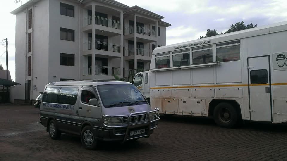Sky Hotel building and the hotel van in the parking compound
